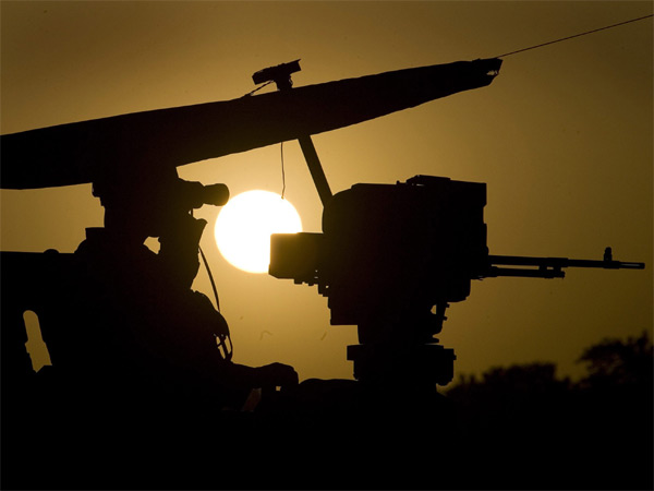 A Canadian soldier from the Royal Canadian Horse Artillery, stands watch in his T-LAV as the sun sets at the forward operating base in Sperwen Ghar, Afghanistan.(CP / Ryan Remiorz)
