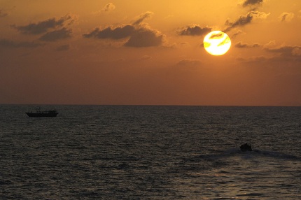 With the setting sun, HMCS Ottawas Naval Boarding Party approach a dhow in a Rigid Hull Inflatable Boat (RHIB) while conducting a boarding operation in the Arabian Gulf. 
