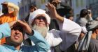 Taliban hang body in Afghan city square, as grip of hardline rule looms
