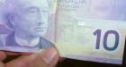Volatile loonie resumes slide