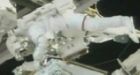 Astronauts take spacewalk despite robot trouble