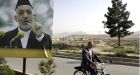 Afghan attacks kill dozens; Karzai leads in poll