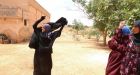 Syrian women pictured throwing off niqabs after their village was freed from Isis