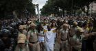 Riot police open way for Olympic torch through protest