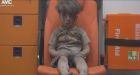 Haunting image circulates of Syrian boy rescued from Aleppo rubble